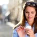 Woman sending a text message on her mobile phone