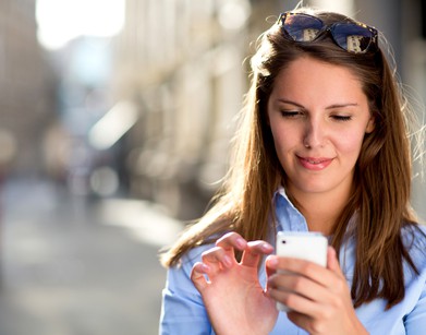 Woman sending a text message on her mobile phone